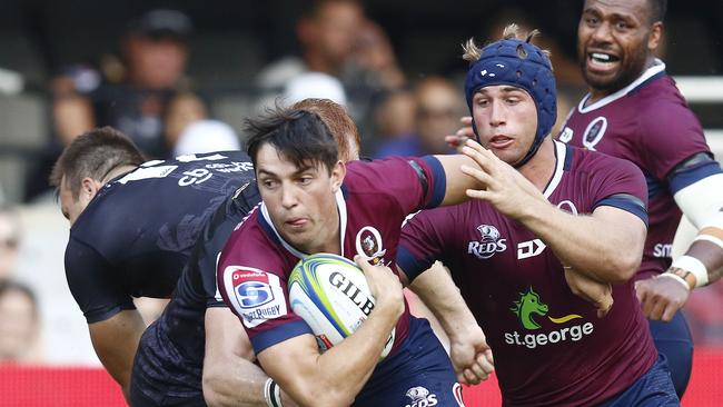 Jock Campbell (L) of the Queensland Reds runs with the ball next to teammate and Hamish Stewart (2ndR)  during the Super 14 rugby union match Sharks vs Queensland Reds at the Kings Park rugby stadium in Durban, on 19 April 2019. (Photo by Anesh Debiky / AFP)