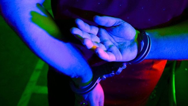 Cairns police generic handcuffs night