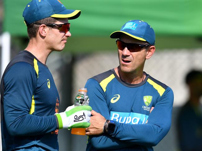 Australia coach Justin Langer (right), pictured with captain Tim Paine, has had his hours reduced to two days a week.