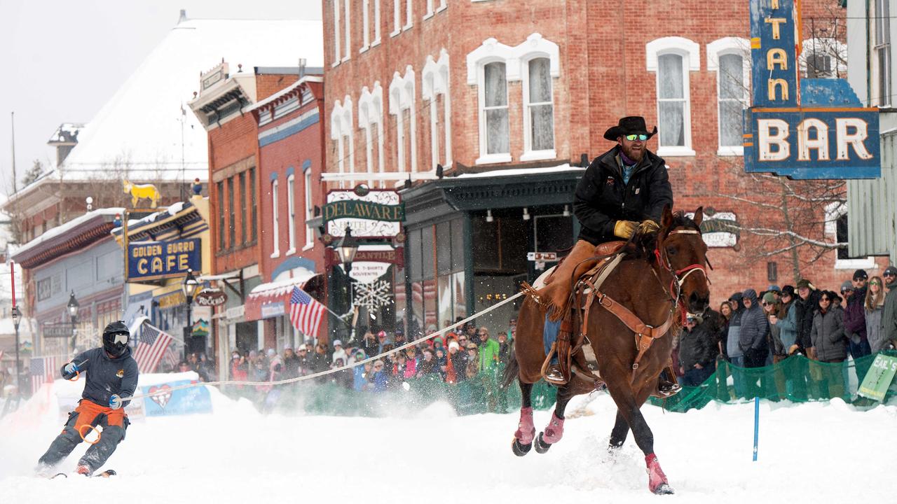 A skier is towed down Harrison Avenue during Leadville Ski Joring event - a thrilling sport blending skiing with horseback riding - that has been hosted in the city since 1949. Picture: Jason Connolly/AFP