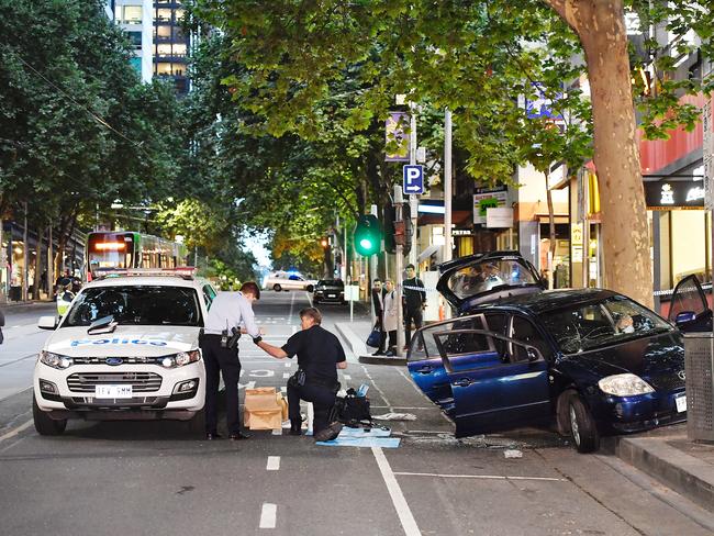 A car surrounded by police on Bourke St. Picture: Jason Edwards