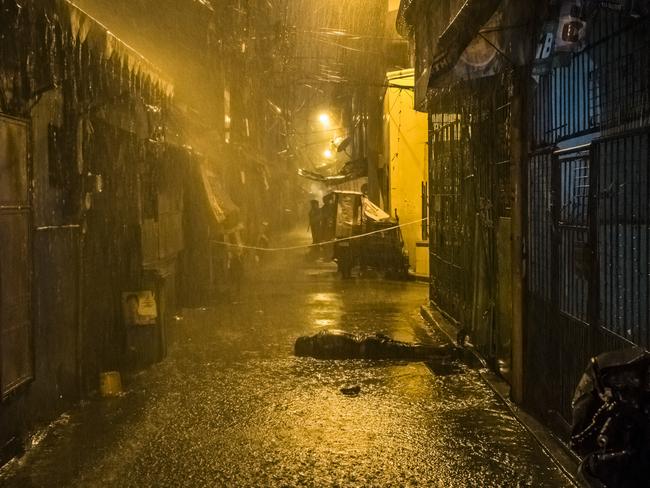 Rain pours onto the body of Romeo Torres Fontanilla, who was allegedly gunned down by two unknown men on a motorbike, in the Pasay district of Manila. Picture: Daniel Berehulak/The New York Times/Redux/Headpress