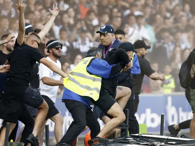 Melbourne Victory fans charge onto AAMI Park. Picture: Darrian Traynor/Getty