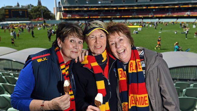 Lifelong Crows fans Glenys Bowden, Gwen Petherick and Dianne Ryan gather at Adelaide Oval to welcome back the players after their loss in Saturday’s AFL Grand Final. Picture: Tom Huntley