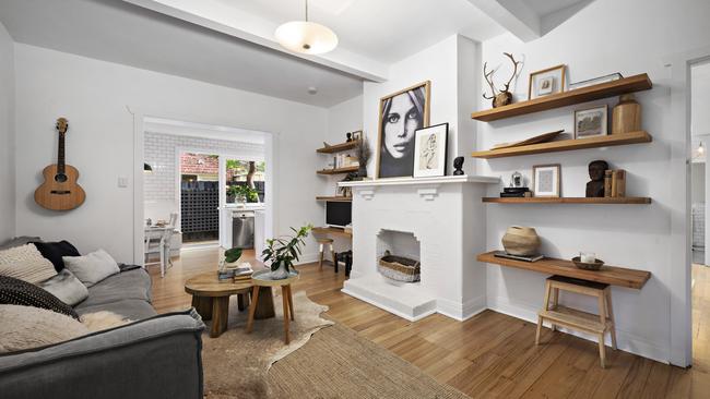 A guitar hanging on the wall pays homage to the apartment’s musical past.