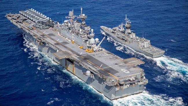 USS America (left) conducts a replenishment at sea off the coast of Queensland, in a historic moment for the American amphibious assault ship, during Exercise Talisman Sabre 2021. Picture: LSIS Ernesto Sanchez/ADF