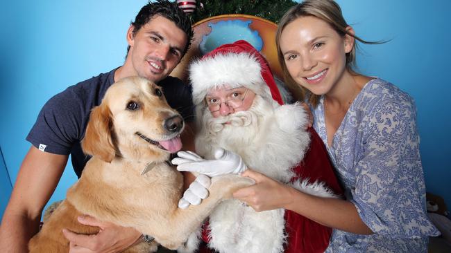 Santa gets a visit from Collingwood captain Scott Pendlebury, his wife Alex and dog Lenny. Picture: Alex Coppel