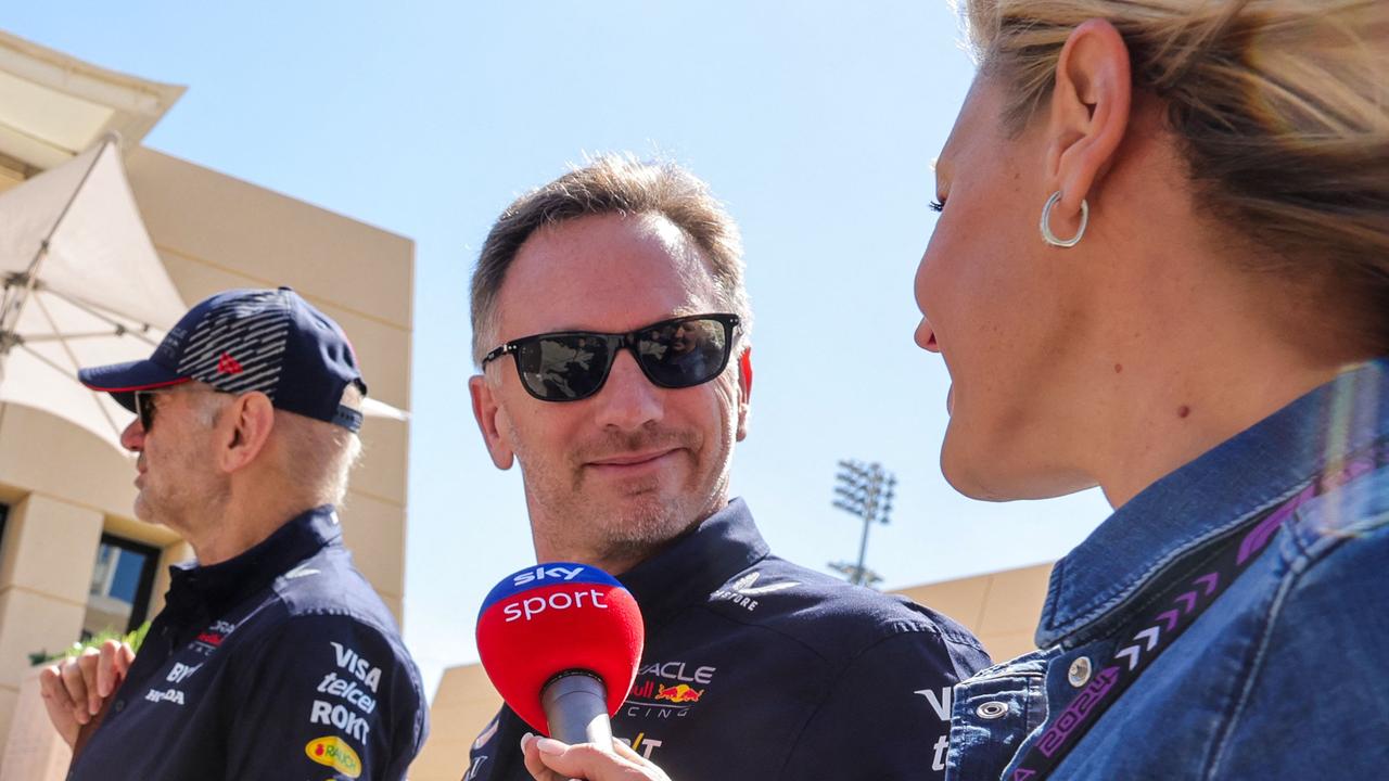 Red Bull Racing team principal Christian Horner (C) speaks to a reporter as he arrives at the Bahrain International Circuit. (Photo by Giuseppe CACACE / AFP)