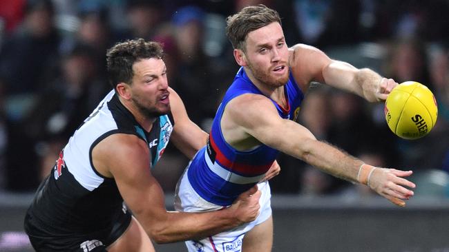 Port captain Travis Boak tackles Hayden Crozier. Picture: AAP Image/David Mariuz