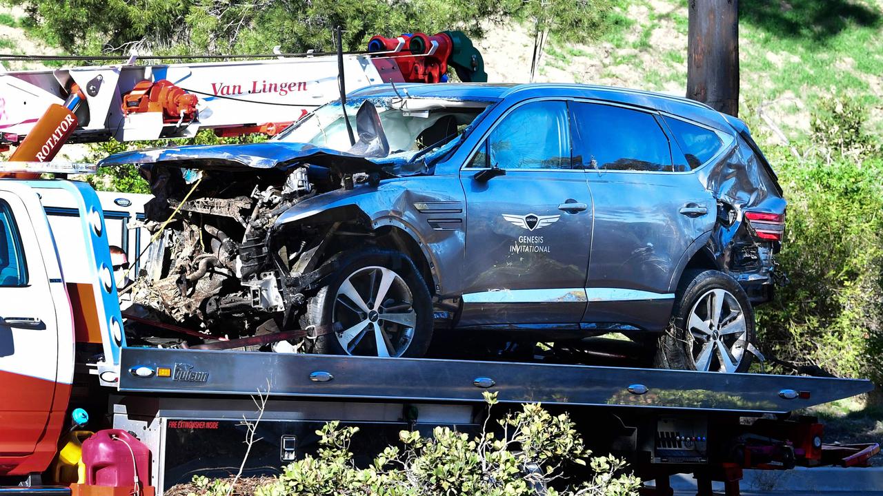 Tiger Woods’ damaged car is loaded onto a tow truck. Picture: AFP