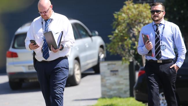 Detectives talk to neighbours in Harrington Park. Picture: John Grainger