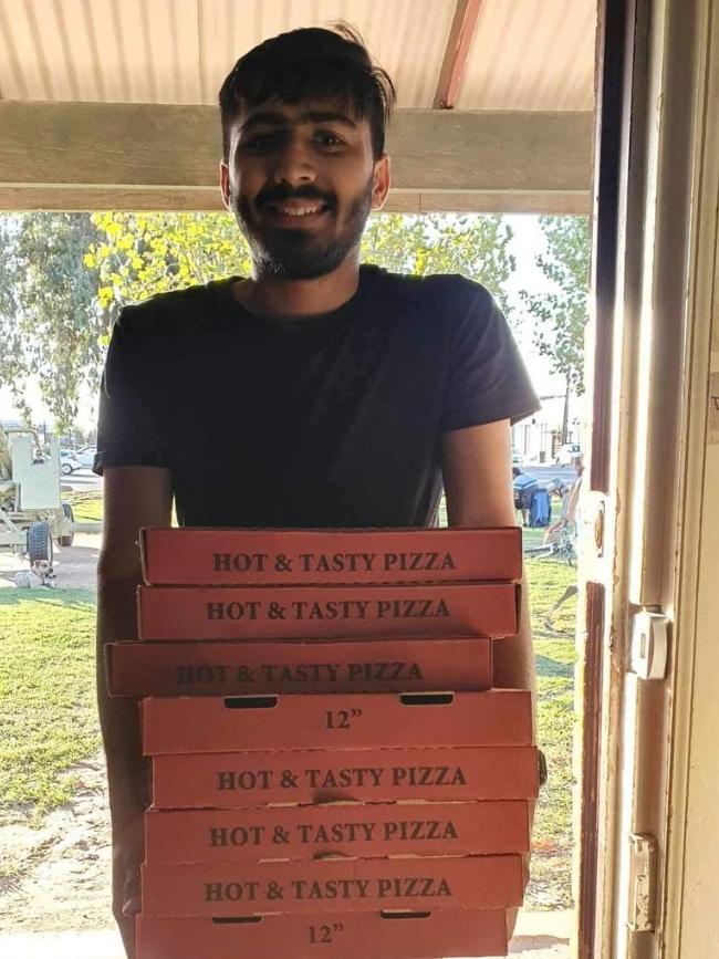 Delivery driver Rishi, 22, with some of the pizzas ordered and donated to Puddle Jumpers. Picture: Facebook