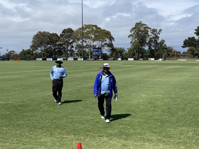 Umpire Cliff D’Souza (right) during his 800th game on Saturday.