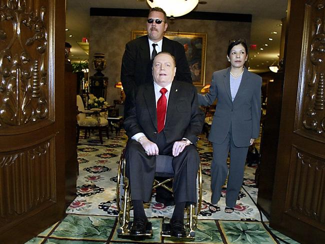 Hustler magazine publisher Larry Flynt arrives at his Beverly Hills office in his gold plated wheelchair with wife Liz in 2003