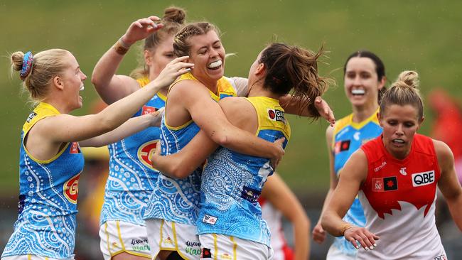 SYDNEY, AUSTRALIA - OCTOBER 08: Claudia Whitfort of the Suns celebrates with her team after kicking a goal during the round seven AFLW match between the Sydney Swans and the Gold Coast Suns at Henson Park on October 08, 2022 in Sydney, Australia. (Photo by Mark Kolbe/Getty Images)