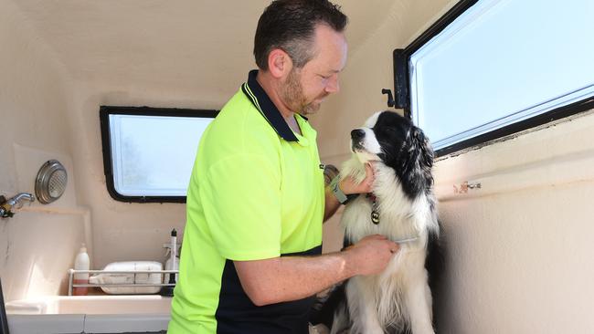 Mr Hogan in his mobile grooming van with Hero. Picture: Josie Hayden