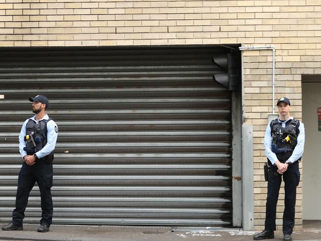 AFP officers guard the rear doors of the CFMEU in Pyrmont. Picture: John Grainger