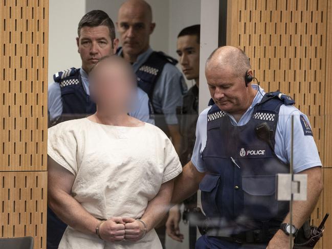 The man charged in relation to the Christchurch mosque massacre Brenton Harrison Tarrant is lead into the dock for his appearance for murder, in the District Court, Christchurch. Picture: AAP