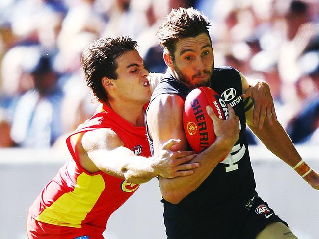 MELBOURNE, AUSTRALIA - MARCH 31:  Jack Bowes of the Suns tackles Dale Thomas of the Blues during the round two AFL match between the Carlton Blues and the Gold Coast Suns at Etihad Stadium on March 31, 2018 in Melbourne, Australia.  (Photo by Michael Dodge/Getty Images)