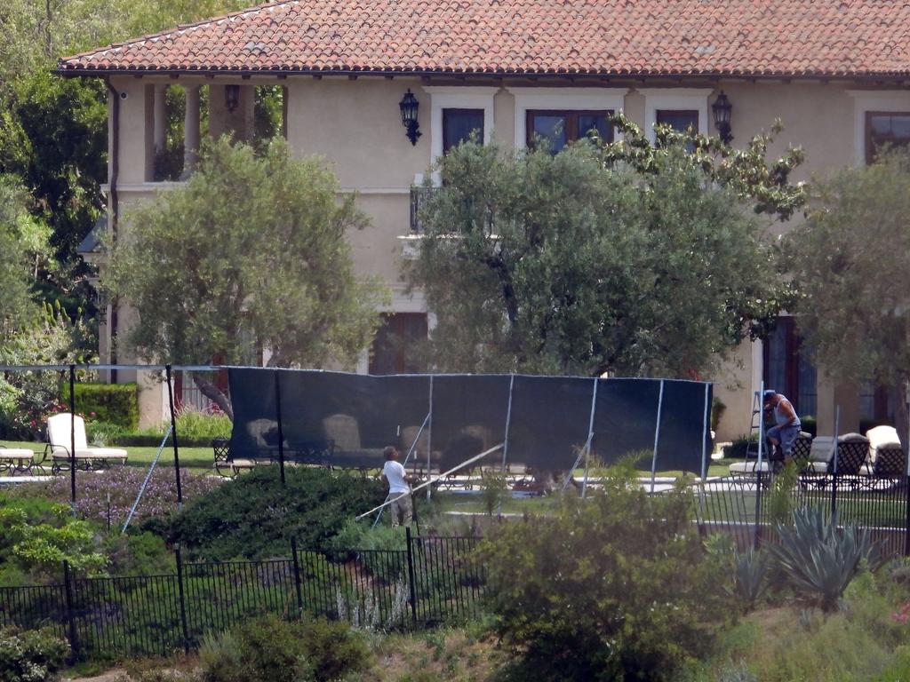 Pictures taken from nearby hiking trails of black screens going up around the Beverly Hills mansion were Meghan and Harry are reportedly living. Picture: BACKGRID Australia