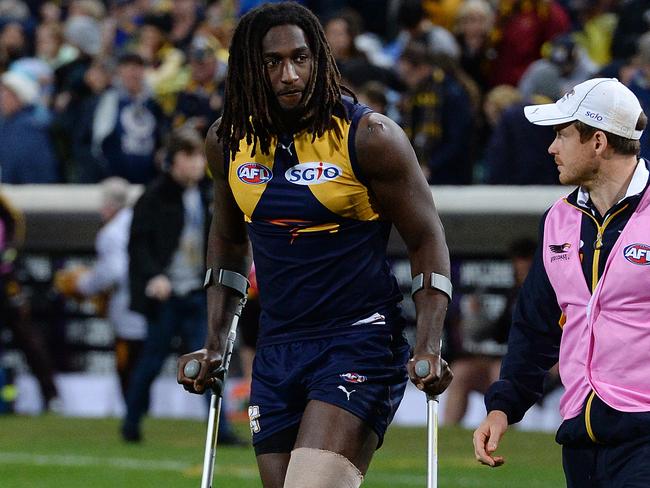 West Coast's Nic Naitanui leaves the field on crutches after Friday night’s win over Hawthorn at Subiaco Oval. Picture: Daniel Wilkins