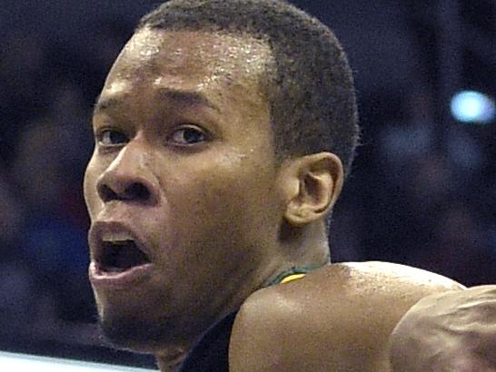 Utah Jazz guard Rodney Hood (5) passes the ball behind his back past Orlando Magic forward Kyle O'Quinn (2) during the second half of an NBA basketball game in Orlando, Fla., Friday, Dec. 19, 2014. The Jazz won 101-94.(AP Photo/Phelan M. Ebenhack)