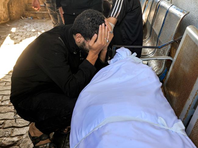 A man reacts by one of the bodies of victims who died in an overnight blast at the Ahli Arab hospital in central Gaza. Picture: AFP