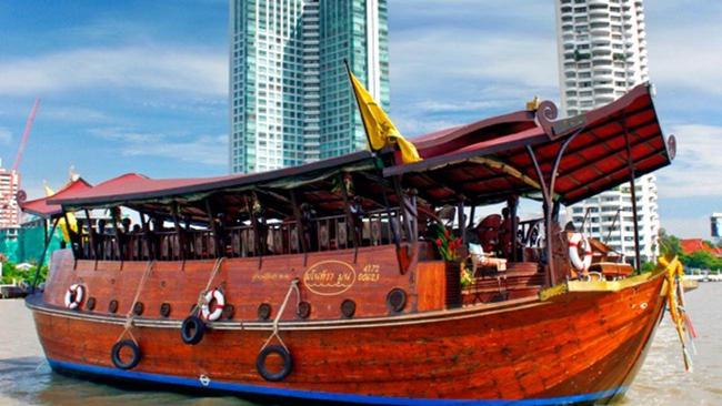 A Manohra Cruises boat on the river in Bangkok.