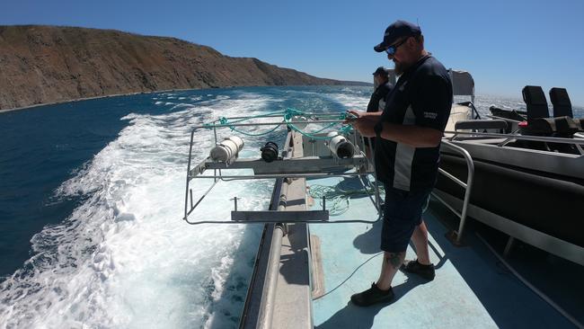 PIRSA senior fisheries officer/engineer Shane Gassen and senior fisheries officer/first mate Steven Kempster deploying the Baited Underwater Remote Video Systems (BRUVS) unit during a research expedition off the remote western coast of Kangaroo Island. Picture: Jamie Hicks/Department for Environment and Water