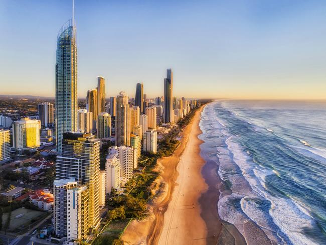 ESCAPE 9 JAN 2022. SAVVY. Waterfront behind sandy beach of SUrfers paradise greeting rising sun over Pacific ocean. Aerial view along Gold Coast and line of high-rise towers. Picture: iStock