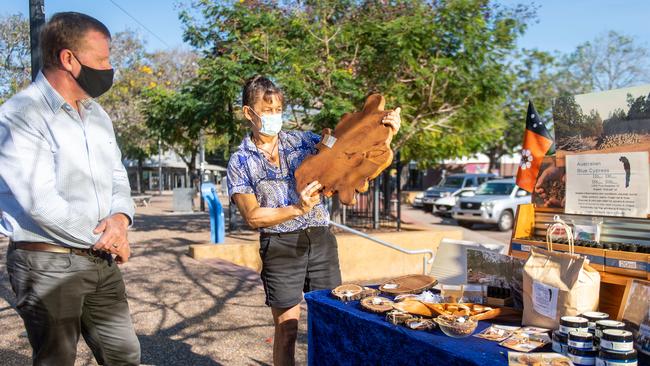 The Minister for Small Business Hon Paul Kirby addresses the media regarding the probable lifting of restrictions allowing markets to once again go ahead across the Top End. He is pictured here with stall holder Maryanne Collins. Picture: Che Chorley