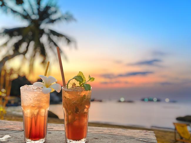 drinks with blur beach and sunset in background