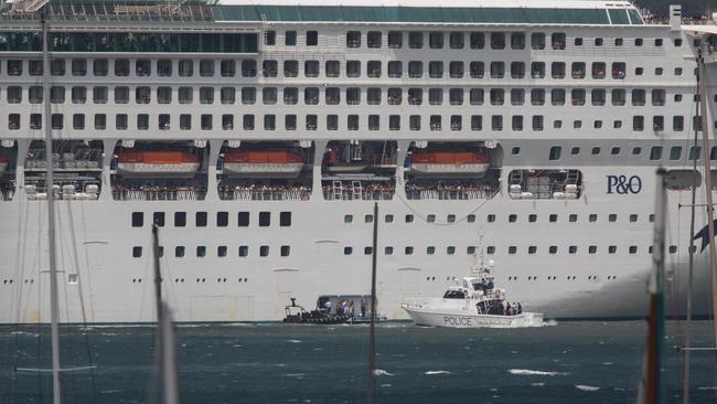 A police patrol boat nears the cruise liner. Adolfo Nazario.