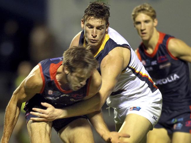 Adelaide Crows Josh Jenkins tackles Norwood’s Brady Dawe last Friday night. Picture Dean Martin