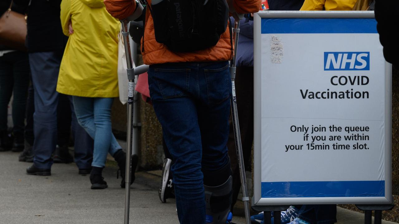 Queues of people waiting for their Covid-19 booster jab snake around the grounds of St Thomas’ hospital on December 13, 2021 in London. Picture: Leon Neal/Getty Images