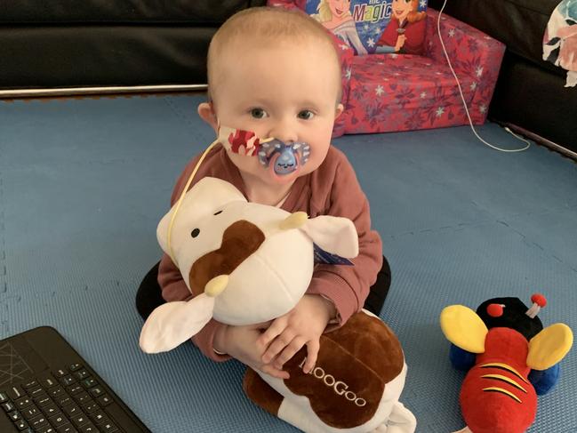 Little Grace Bridges cuddles her MooGoo cow.