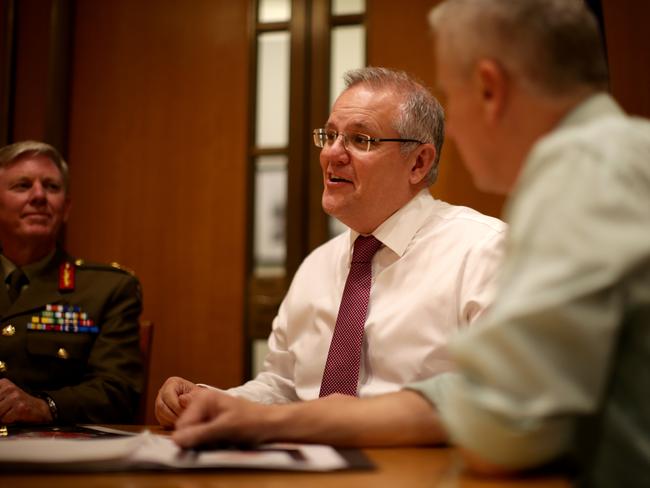 PM Scott Morrison talking with deputy PM Michael McCormack and National drought coordinator Major General Stephen Day at Parliament House in Canberra. Picture Jonathan Ng