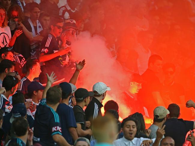 Victory fans let off flares during the Melbourne derby.