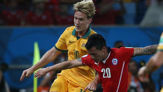 Australia's Ben Halloran battles with Charles Aranguiz of Chile at Arena Pantanal in a Group B match at the 2014 FIFA World Cup in Brazil. Pic : George Salpigtidis