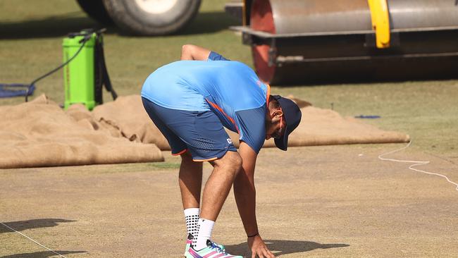 DELHI, INDIA - FEBRUARY 15: Rohit Sharma of India checks the pitch during an Indian Test squad training session at Arun Jaitley Stadium on February 15, 2023 in Delhi, India. (Photo by Robert Cianflone/Getty Images)