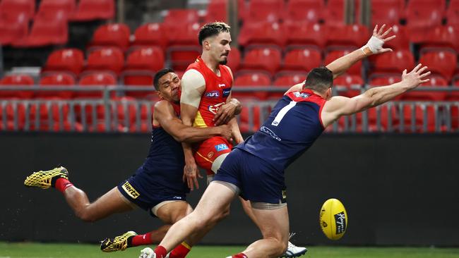 Izak Rankine kicks one of his three goals in heavy traffic. Picture: Getty Images