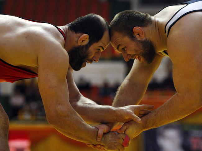 Iran's free style wrestler Fardin Masoumi, left, and his US competitor Tervel Dlagnev fight in Tehran, Iran in 2009. Picture: AP Photo/Vahid Salemi, File