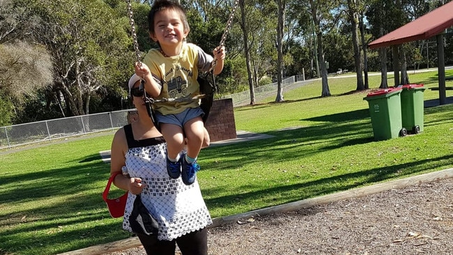 Six-year-old Myka Tuala was the first road fatality of 2021 in New Zealand. His grandmother Va Tuala, pictured pushing him on the swing during a visit to the Gold Coast a few years ago – is in NZ hotel quarantine hoping to get to his funeral on January 15. Photo: Supplied