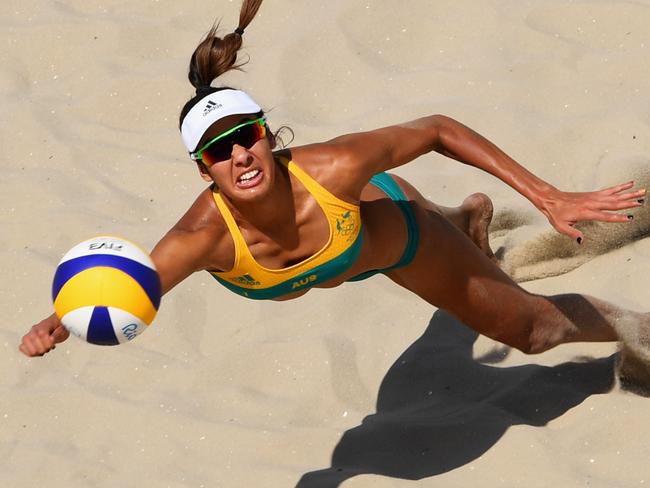 RIO DE JANEIRO, BRAZIL - AUGUST 06: Taliqua Clancy of Australia dives for the ball during the Women's Beach Volleyball preliminary round Pool F match against Natalia Alfaro and Karen Cope Charles of Costa Rica on Day 1 of the Rio 2016 Olympic Games at the Beach Volleyball Arena on August 6, 2016 in Rio de Janeiro, Brazil. (Photo by Quinn Rooney/Getty Images)