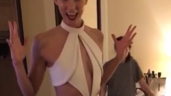 Karlie Kloss gets the bottom of her dress cut off.