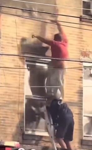 The firefighter who was atop the ladder was able to maintain his grip. Picture: X@dom_lucre