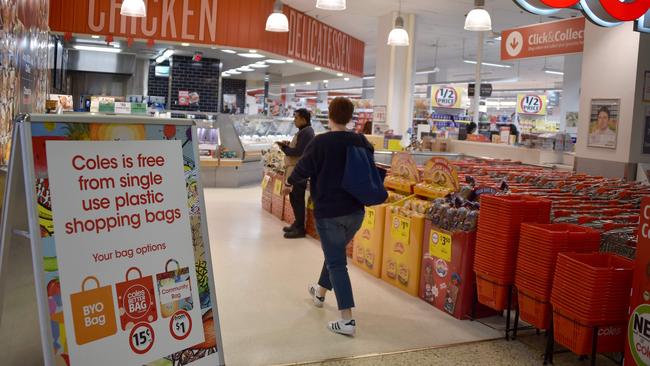 Bag bans and backflips: A sign in a Coles supermarket, advises its customers of its plastic bag. Picture: AFP/Peter Parks