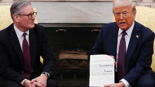 Mr Trump holds the letter. Picture: Carl Court/AFP