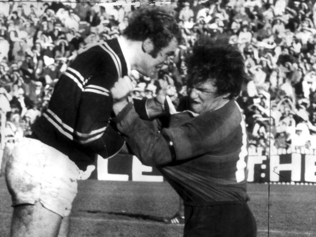 Piggins in his playing days takes on Manly big man Mal Reilly.