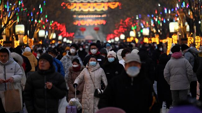 People visit a business street during the Chinese Lunar New Year in Beijing on January 25, 2023. Picture: WANG Zhao / AFP.